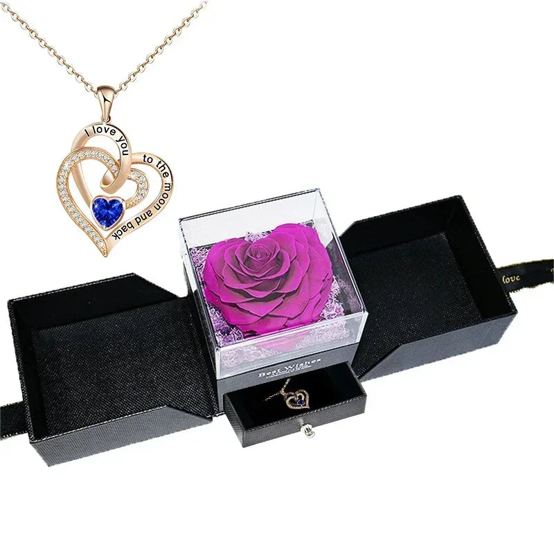 Heart-shaped jewelry box with a preserved rose and necklace inside.