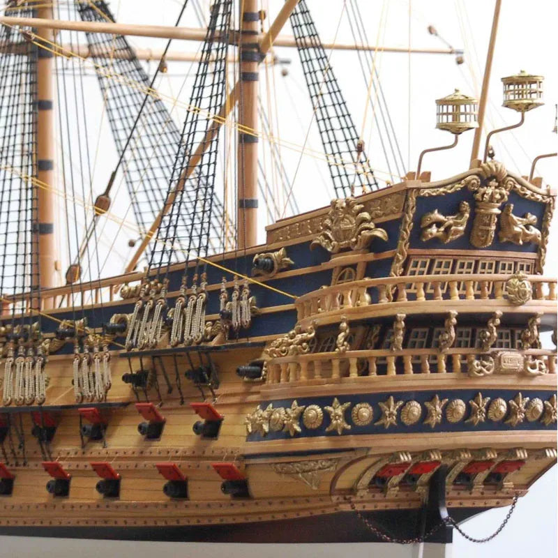 Close-up of a detailed model ship with gold and blue accents.