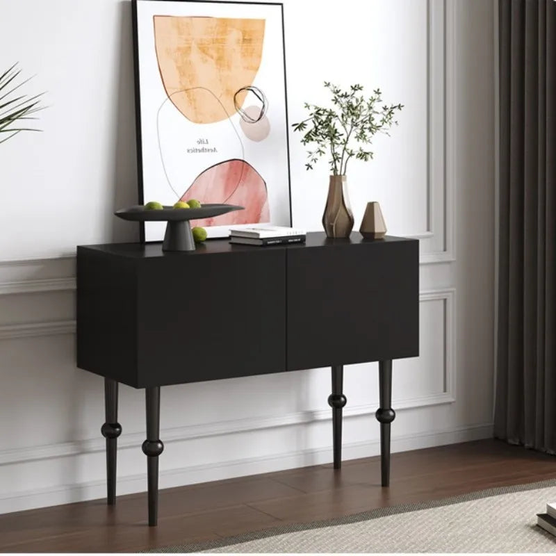 Black console table with decorative items against a white wall