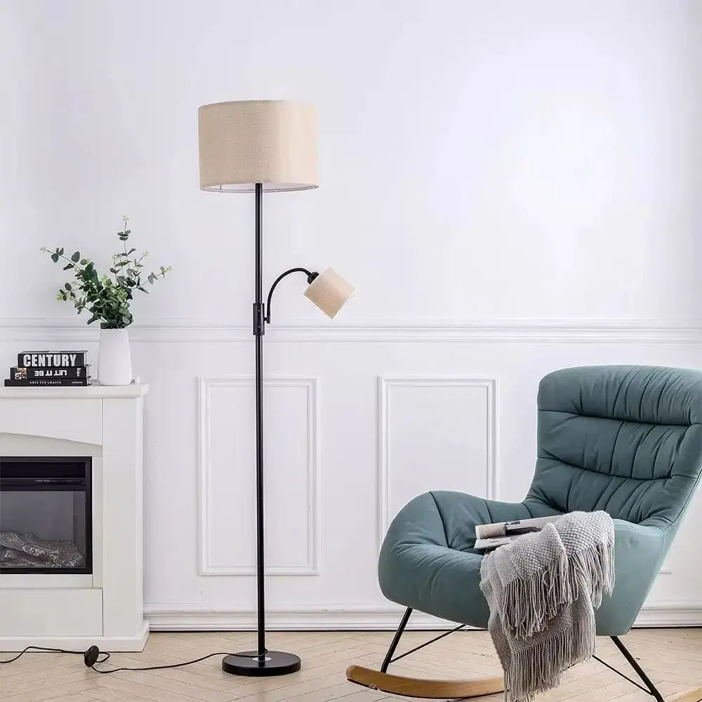 Living room with a floor lamp, armchair, and fireplace.