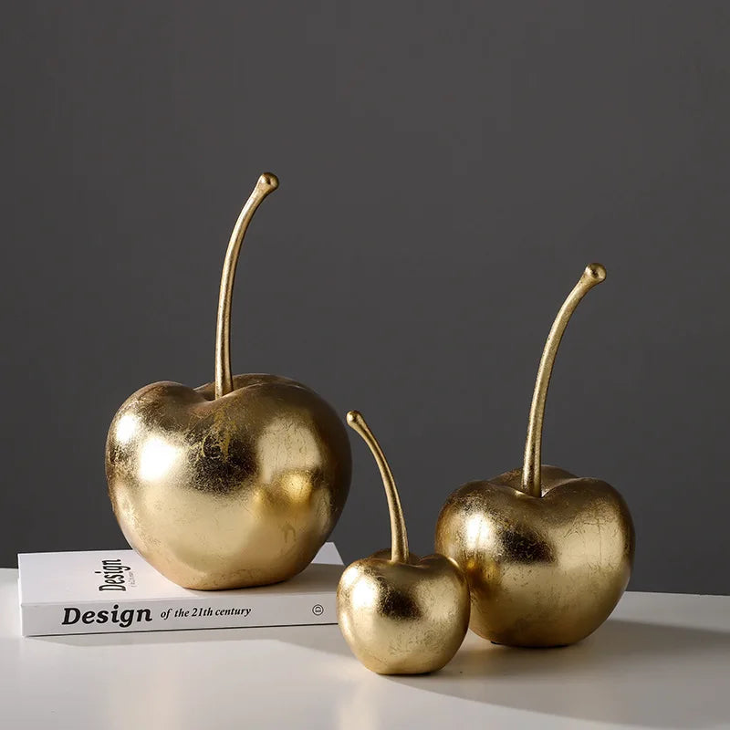 "Resin cherry sculpture in glossy red finish for home decor"