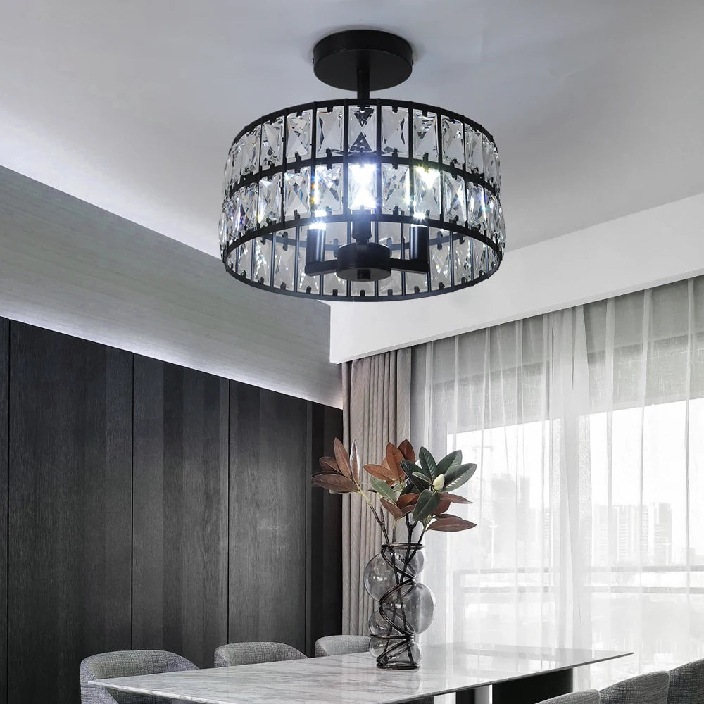 Modern chandelier hanging above a dining table with a vase of flowers in a room.