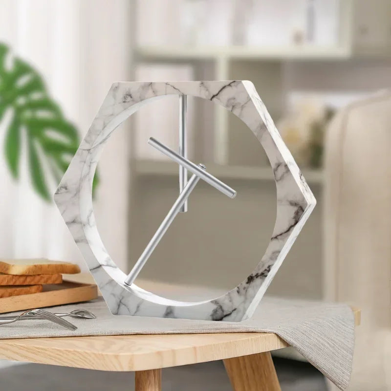 Marble-patterned clock on a table with a blurred background