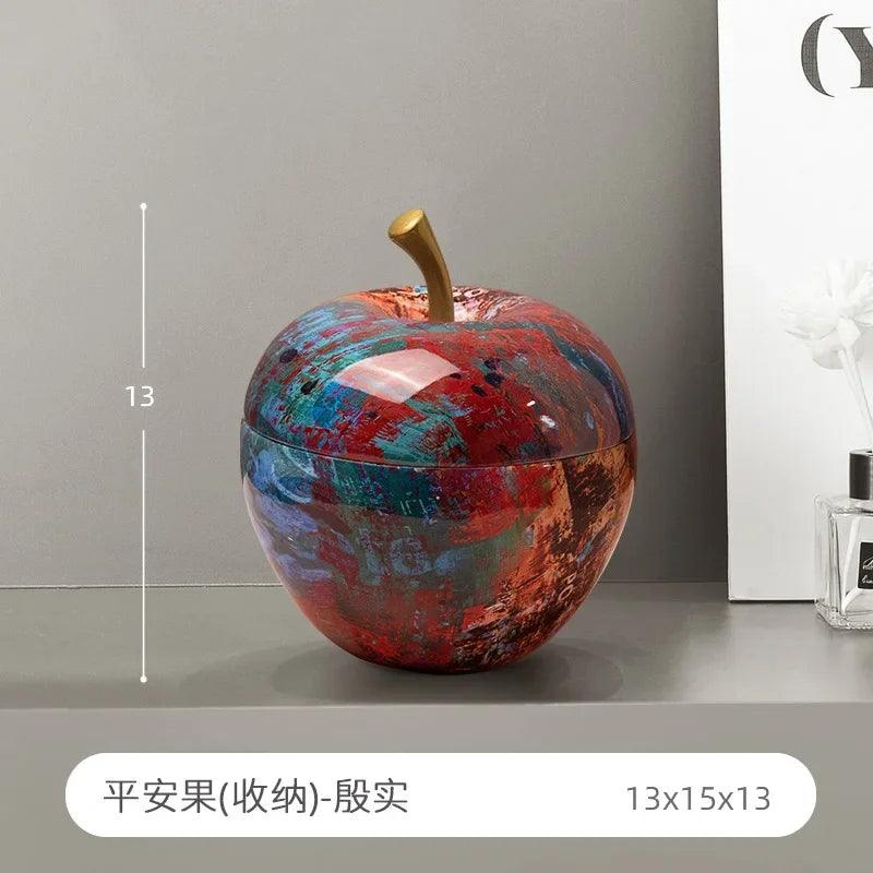 The apple decoration paired with luxury books and vases in a living room setup.