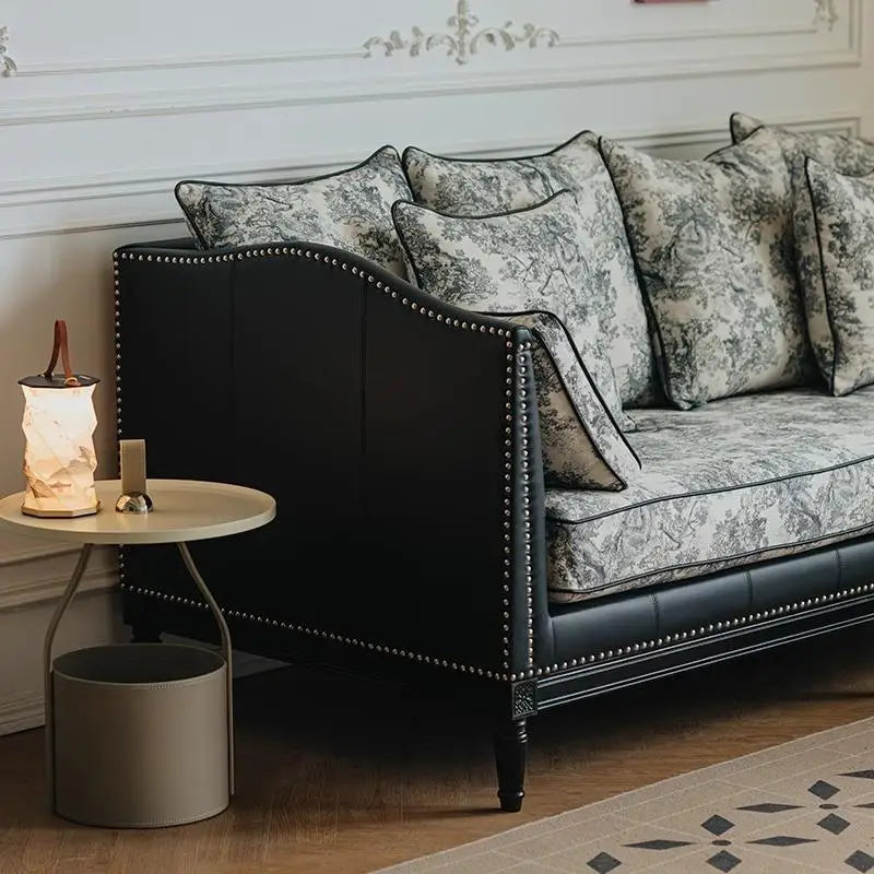 Decorative sofa with patterned cushions in a stylish room.