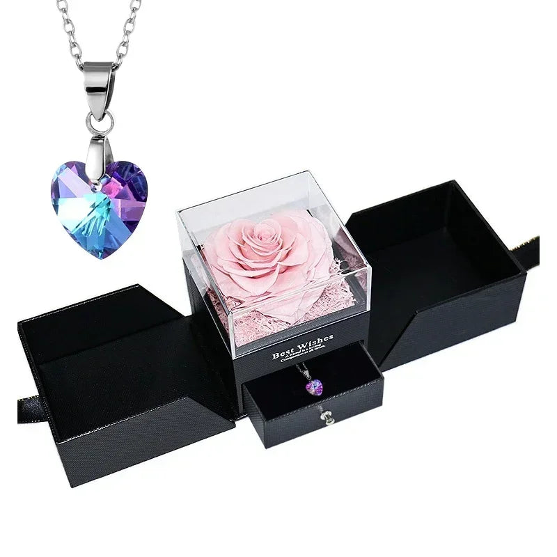 Heart-shaped jewelry box with a preserved rose and necklace inside.