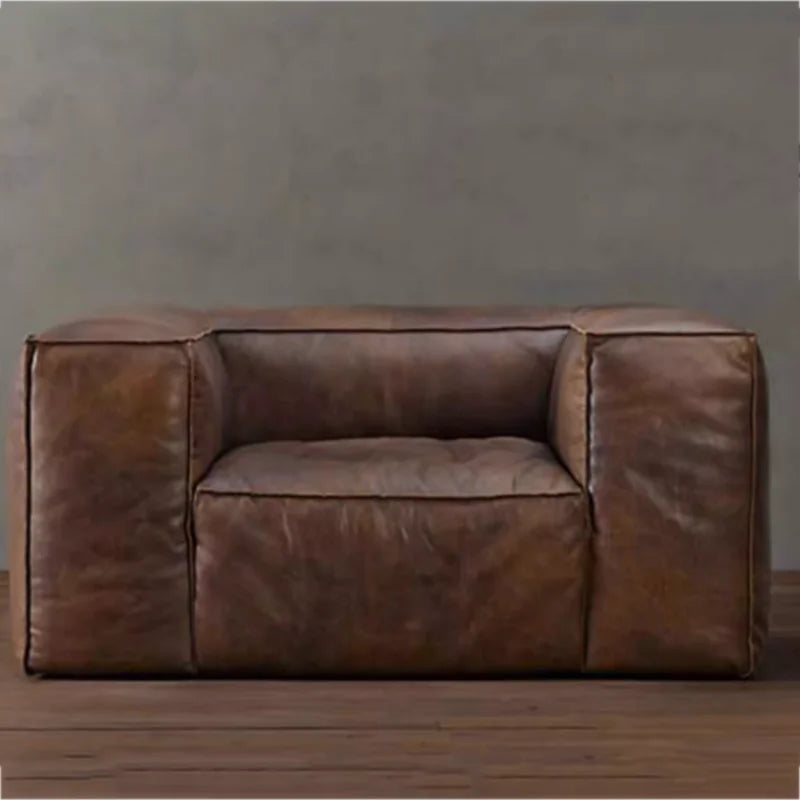 Brown leather sofa against a gray wall