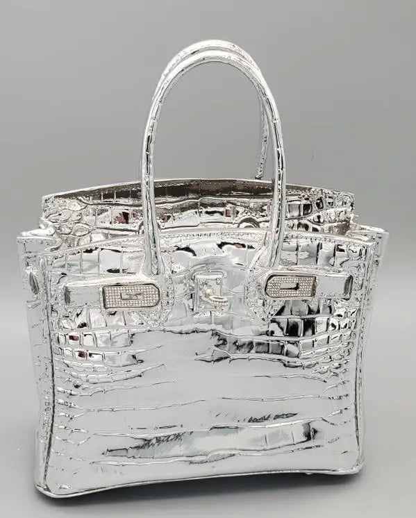 Silver handbag with reflective surface on a grey background  Unique wedding flower vase