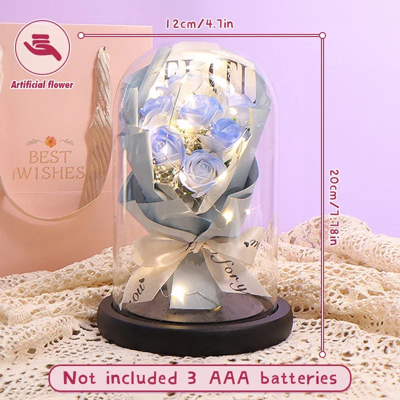 Glass dome with LED lights illuminating the preserved flower arrangement.
