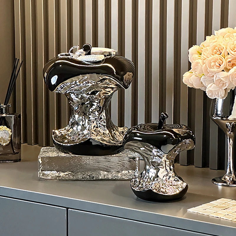 Decorative boot sculpture on a surface with striped wallpaper in the background