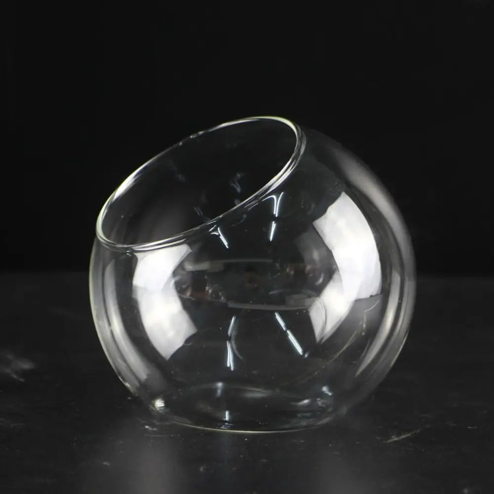 Clear glass fishbowl on a black background