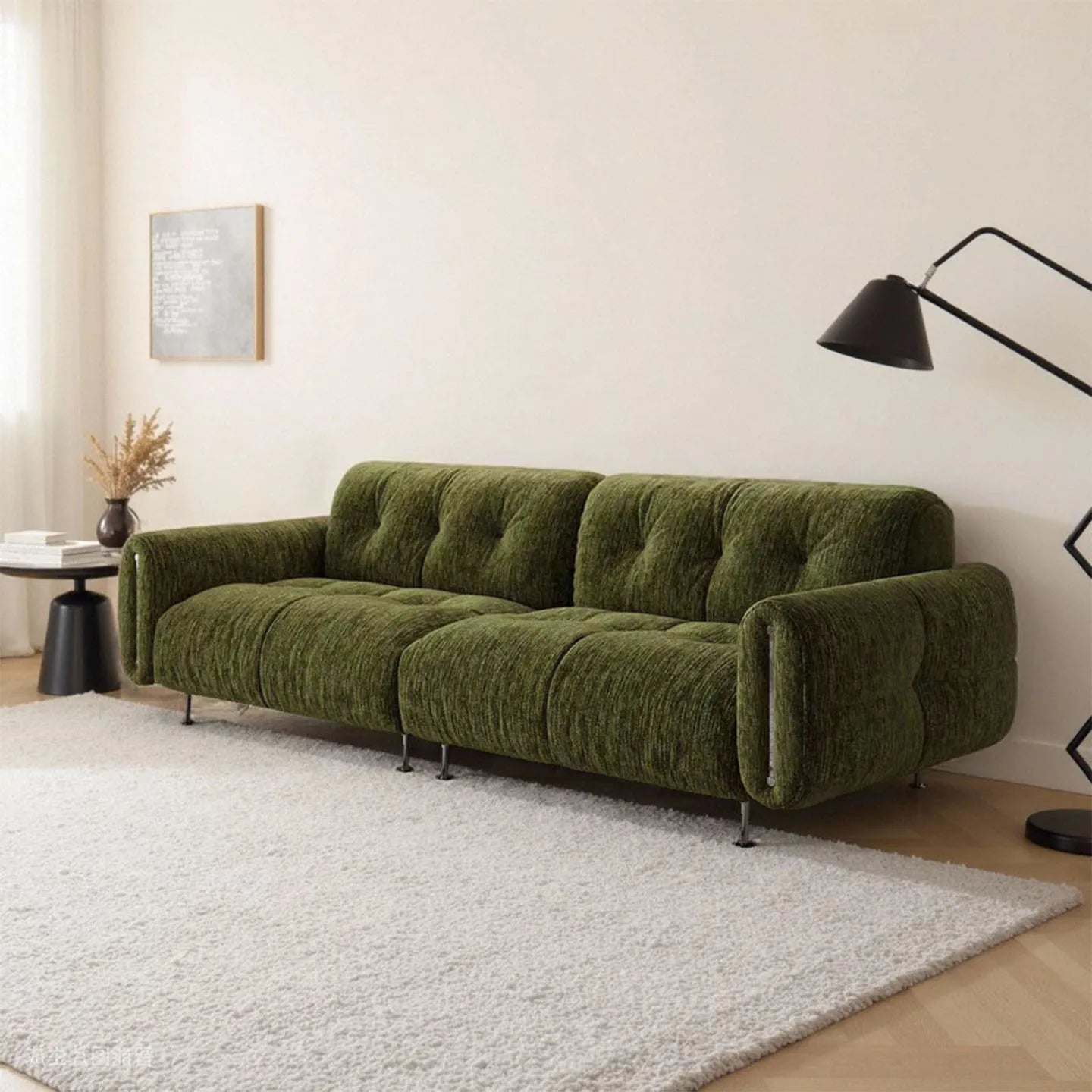 Green sofa in a living room with a lamp and decor items.