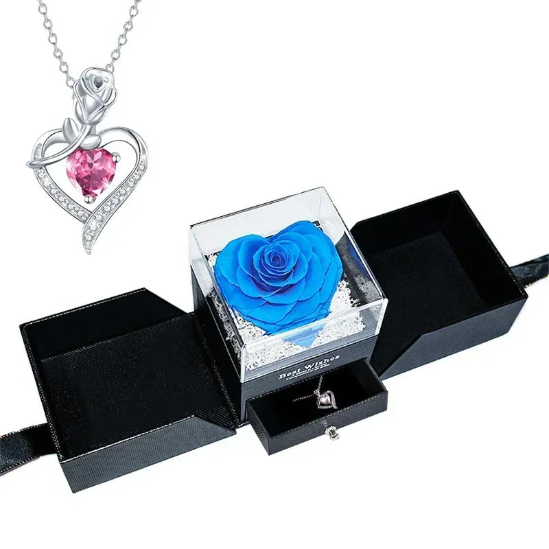 Heart-shaped jewelry box with a preserved rose and necklace inside.