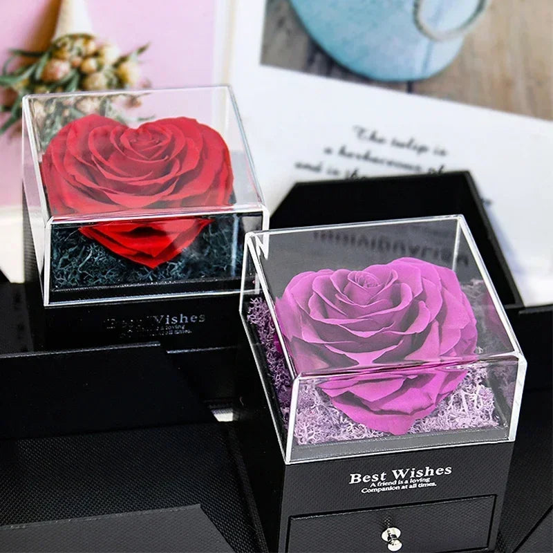Heart-shaped jewelry box with a preserved rose and necklace inside.