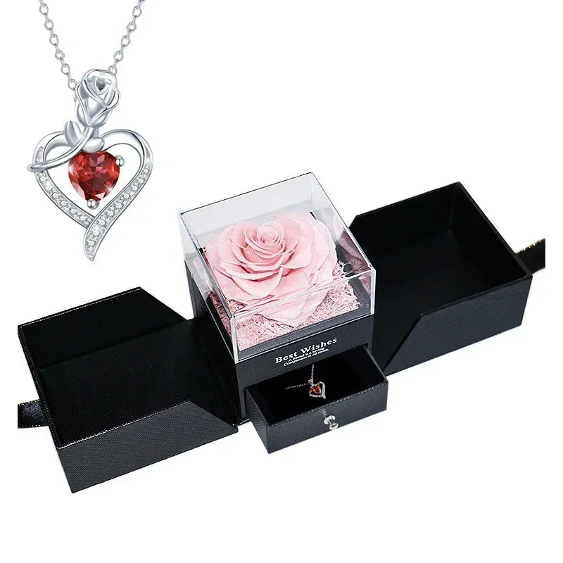 Heart-shaped jewelry box with a preserved rose and necklace inside.