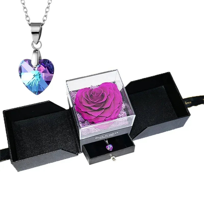 Heart-shaped jewelry box with a preserved rose and necklace inside.