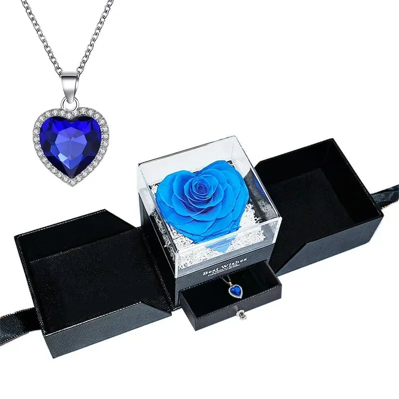Heart-shaped jewelry box with a preserved rose and necklace inside.