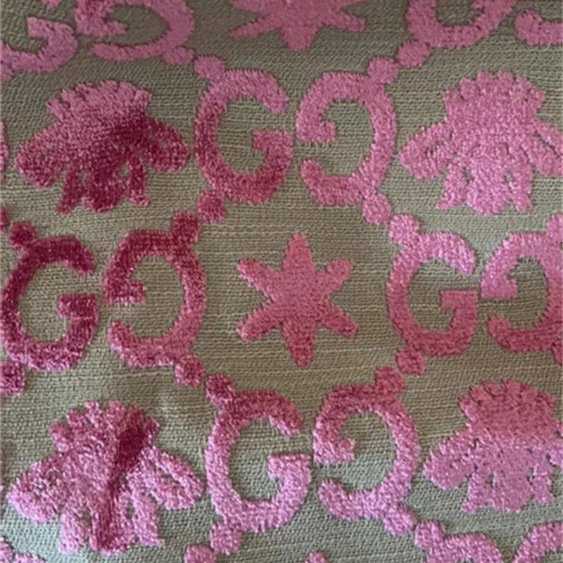 Pink floral and leaf pattern on a green background