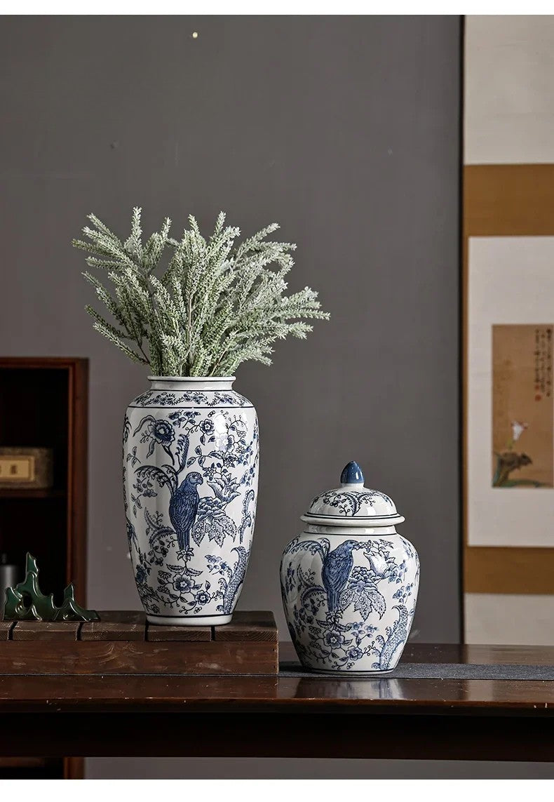 Two blue and white ceramic vases with floral patterns on a wooden surface.