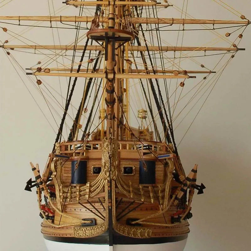 Detailed model of a three-masted sailing ship on a plain background