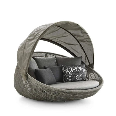 Relaxing outdoor garden round bed chair at sunset.