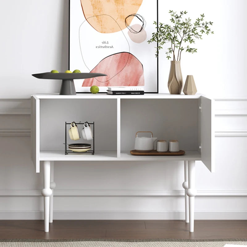 White console table with decorative items against a white wall