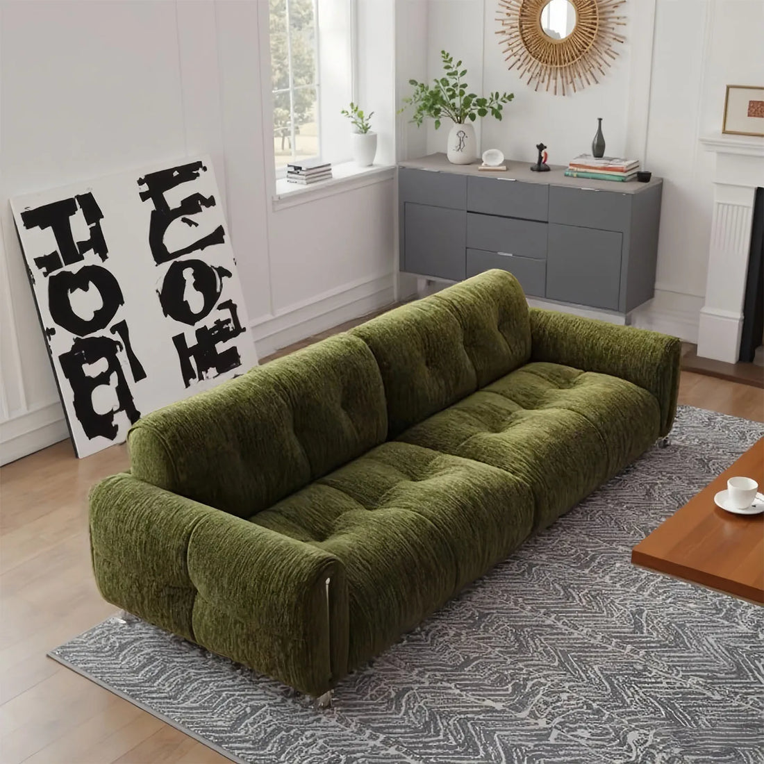 Green sofa in a living room with a coffee table and decorative items.