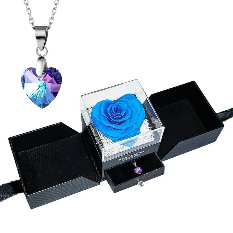 Heart-shaped jewelry box with a preserved rose and necklace inside.