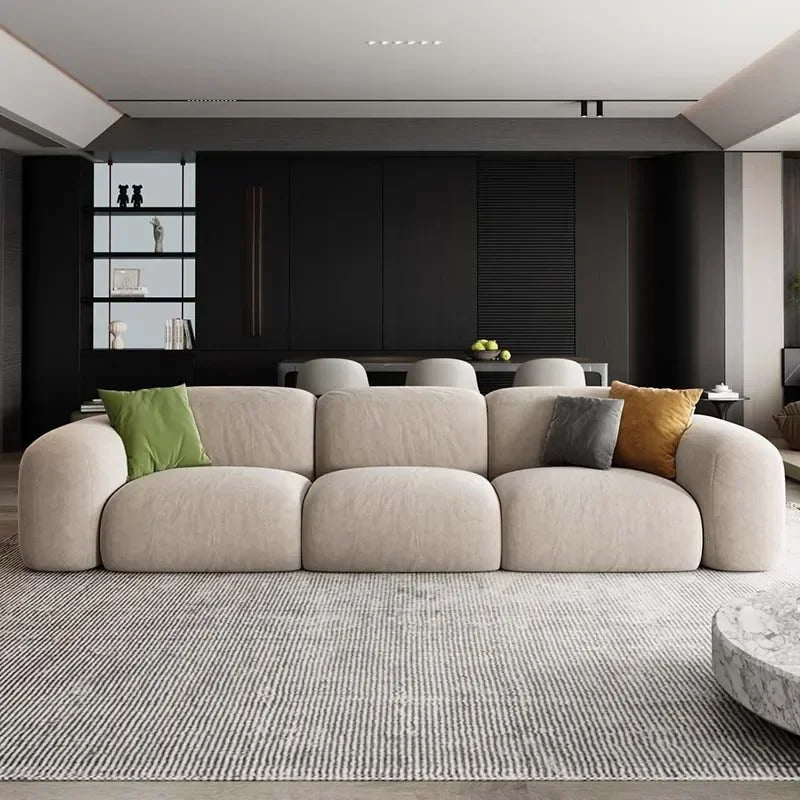 Modern living room with a beige sofa and colorful cushions.