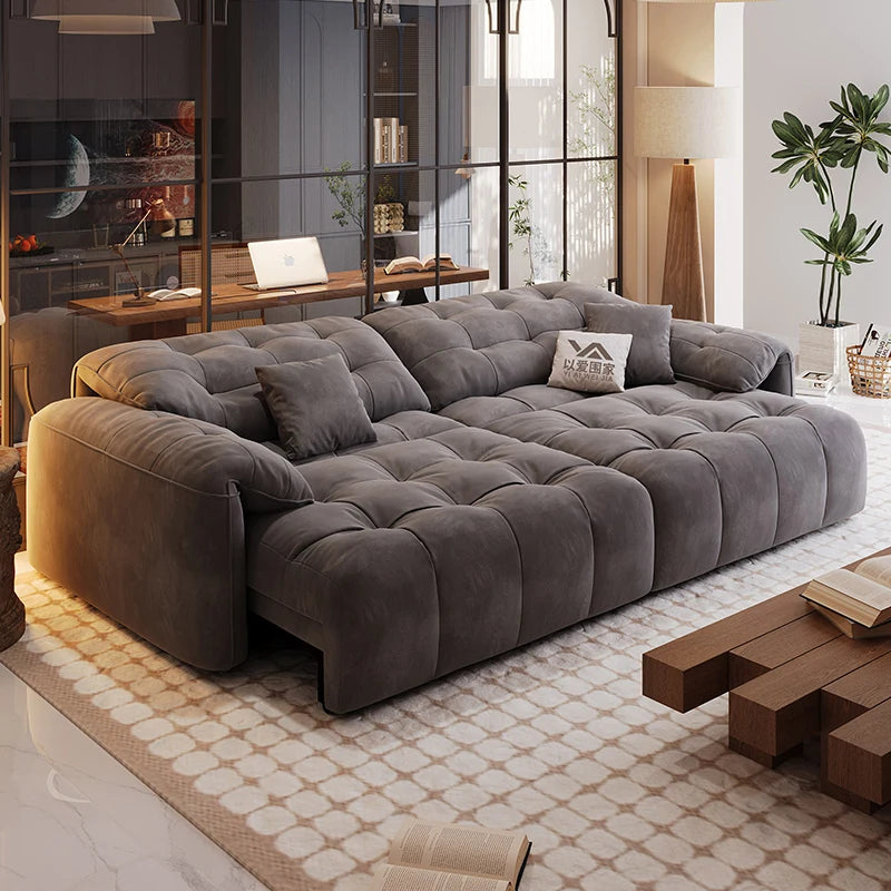 Gray sectional sofa in a modern living room with a coffee table and decor items.