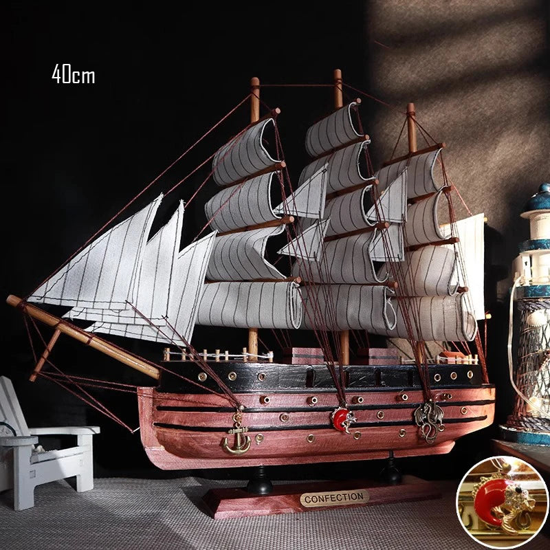 Wooden model ship with detailed sails on a dark background