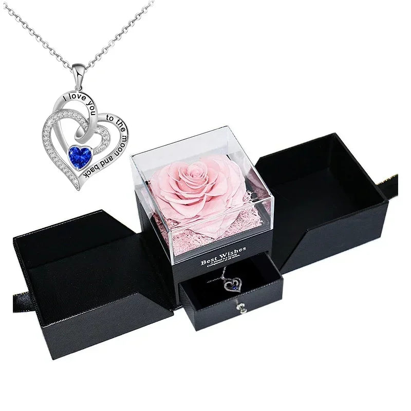 Heart-shaped jewelry box with a preserved rose and necklace inside.