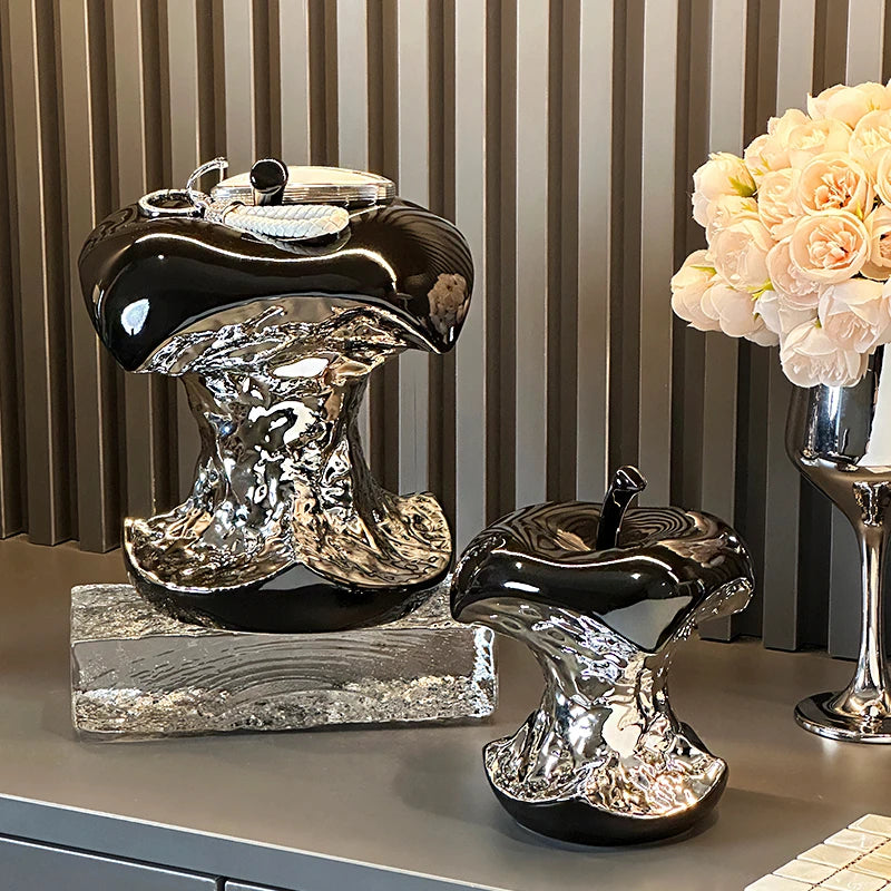 Decorative boot sculptures on a surface with a striped wall in the background