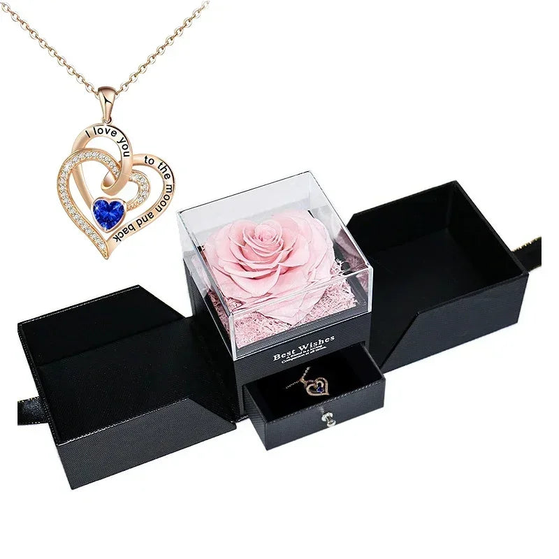 Heart-shaped jewelry box with a preserved rose and necklace inside.