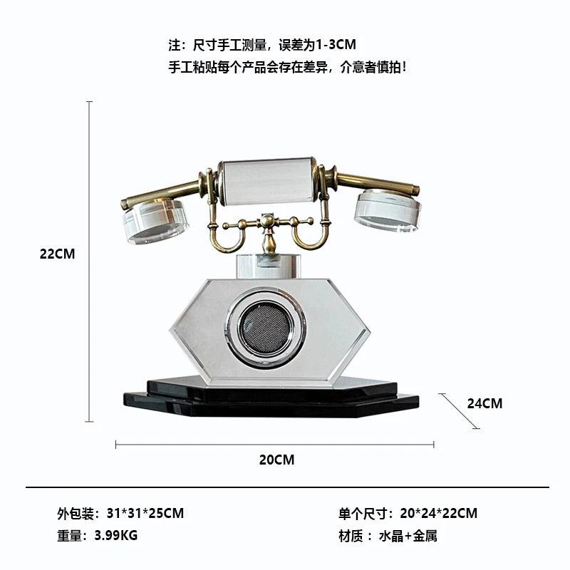 A vintage crystal phone ornament with a metallic finish, featuring a retro design with a rotary dial, earpiece, and hanging crystal elements on a black base.