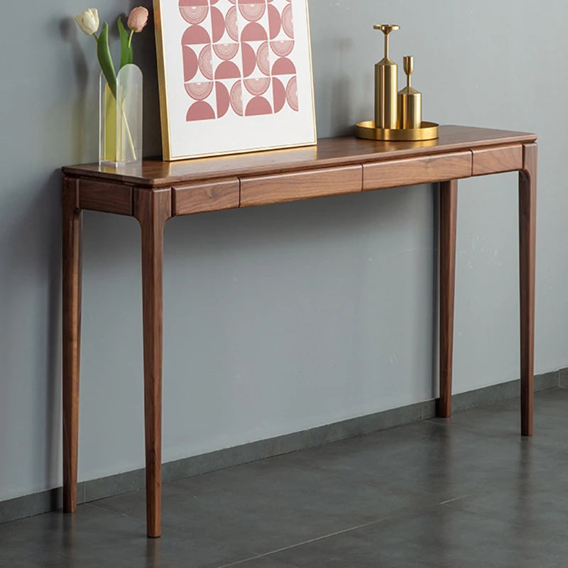 Wooden console table against a gray wall with decorative items on top