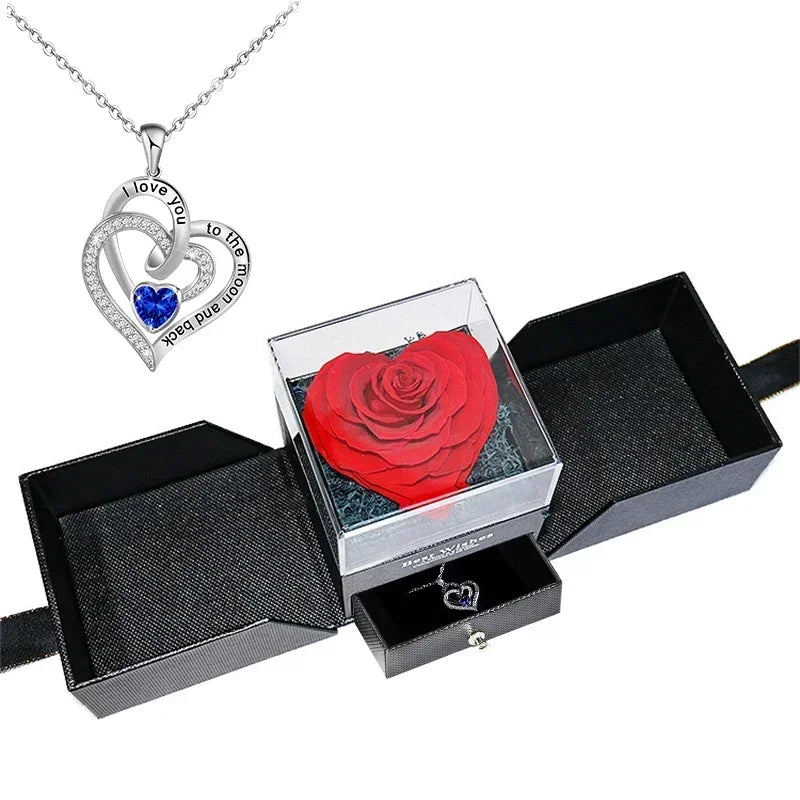 Heart-shaped jewelry box with a preserved rose and necklace inside.