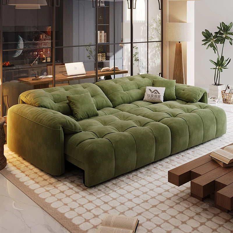 Green sectional sofa in a modern living room with a coffee table and decor items.