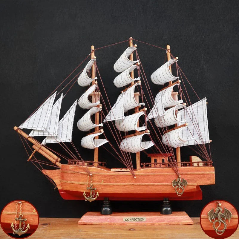 Wooden model ship with white sails on a dark background