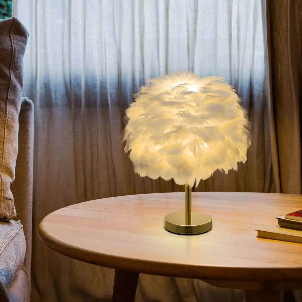 Decorative table lamp with feather design on a wooden table, soft lighting