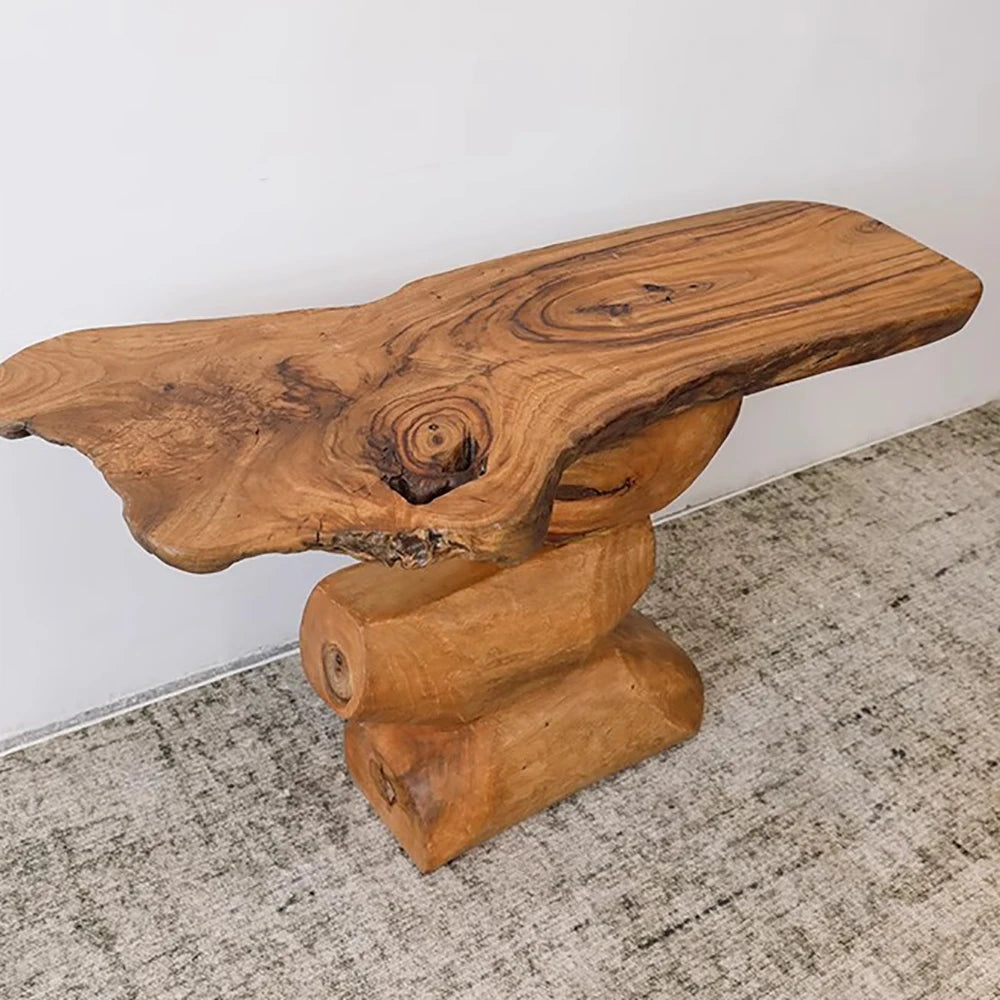 Wooden console table with natural finish on a light gray floor.