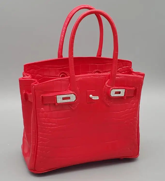 Red handbag with a textured pattern on a grey background White resin flower vase modern design