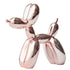 The JONLALA balloon dog sculpture in a modern living room setting.