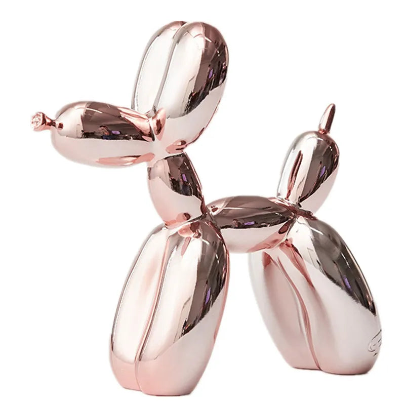 A rose gold-colored balloon dog sculpture by JONLALA, featuring a shiny, plated finish.