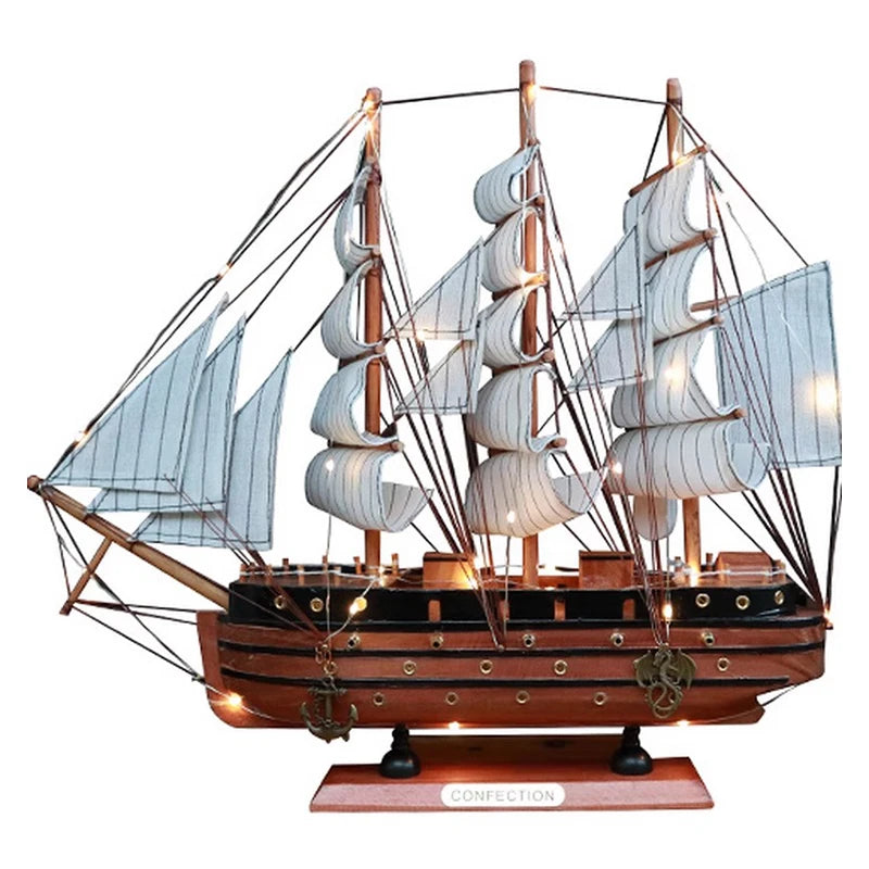 Model ship with multiple sails on a white background