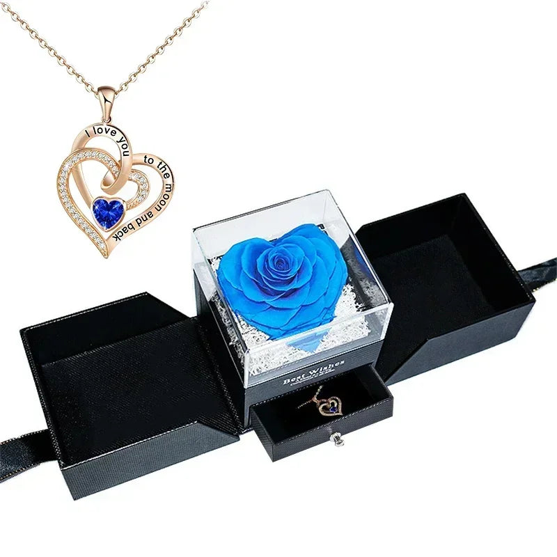 Heart-shaped jewelry box with a preserved rose and necklace inside.