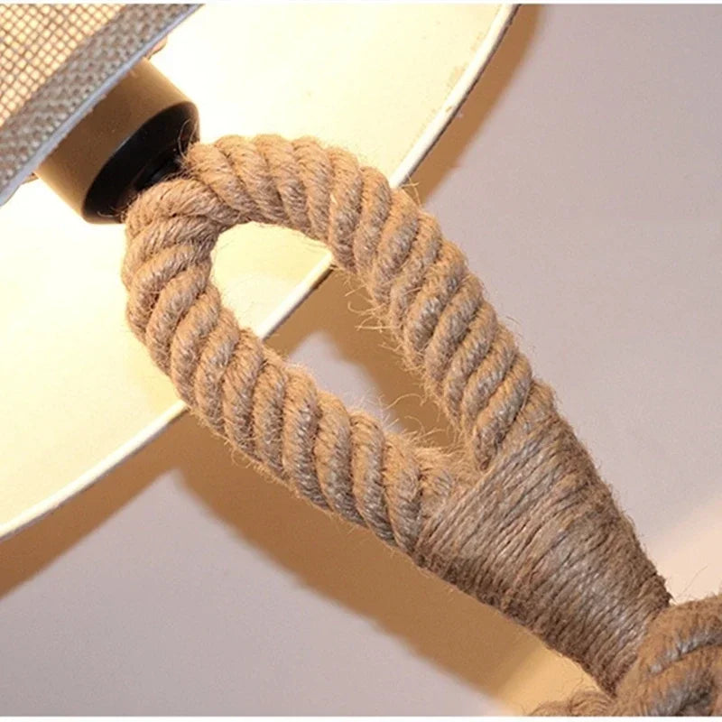 Close-up of a rope wrapped around a cylindrical object with a neutral background