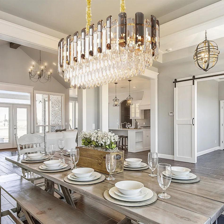Luxurious crystal chandelier hanging above dining table in modern kitchen