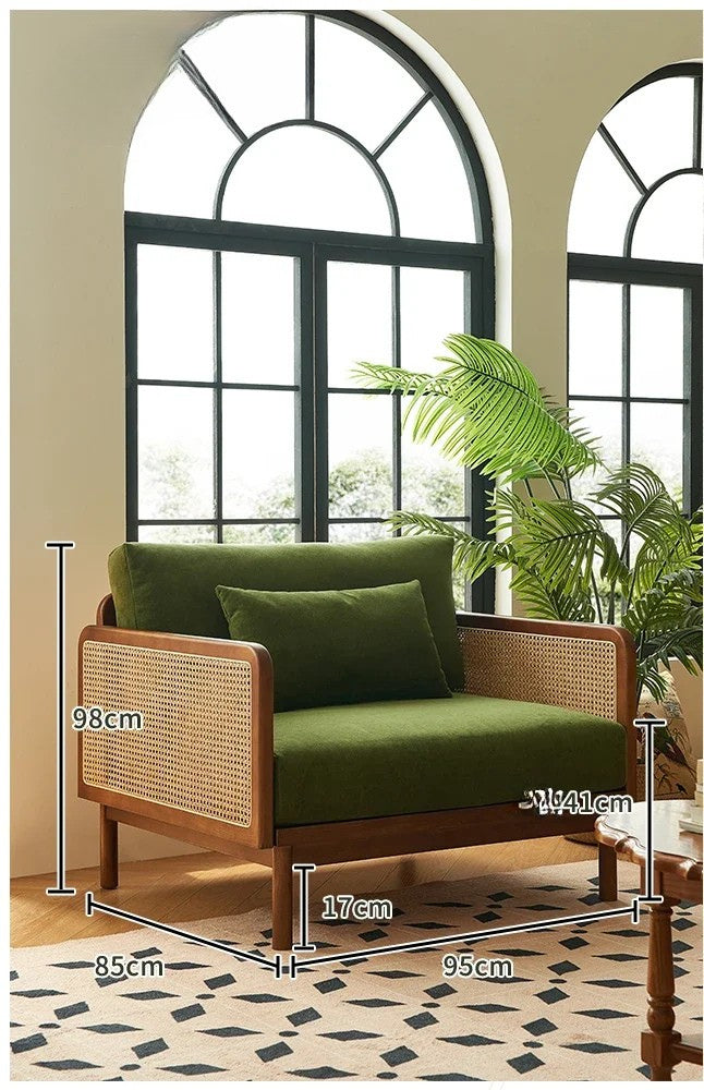 Wooden chair with green cushions and measurements in a room with large windows and plants.