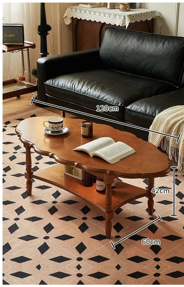 Black leather sofa and wooden coffee table with measurements on a patterned floor.